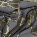 قماش شيفون حرير فرنسي أسود بتصميم لوريكس ذهبي معدني، عرض 110 سم - D21667