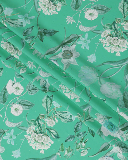 قماش حرير ساتان إيطالي فاخر بقاعدة خضراء نعناعية مع طبعة زهور نباتية باللونين الأبيض والأزرق المخضر، عرض 140 سم، صنع في إيطاليا - D22994