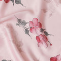 Lemonade pink synthetic crepe fabric with print in black, dark pink and green in floral design-D15654