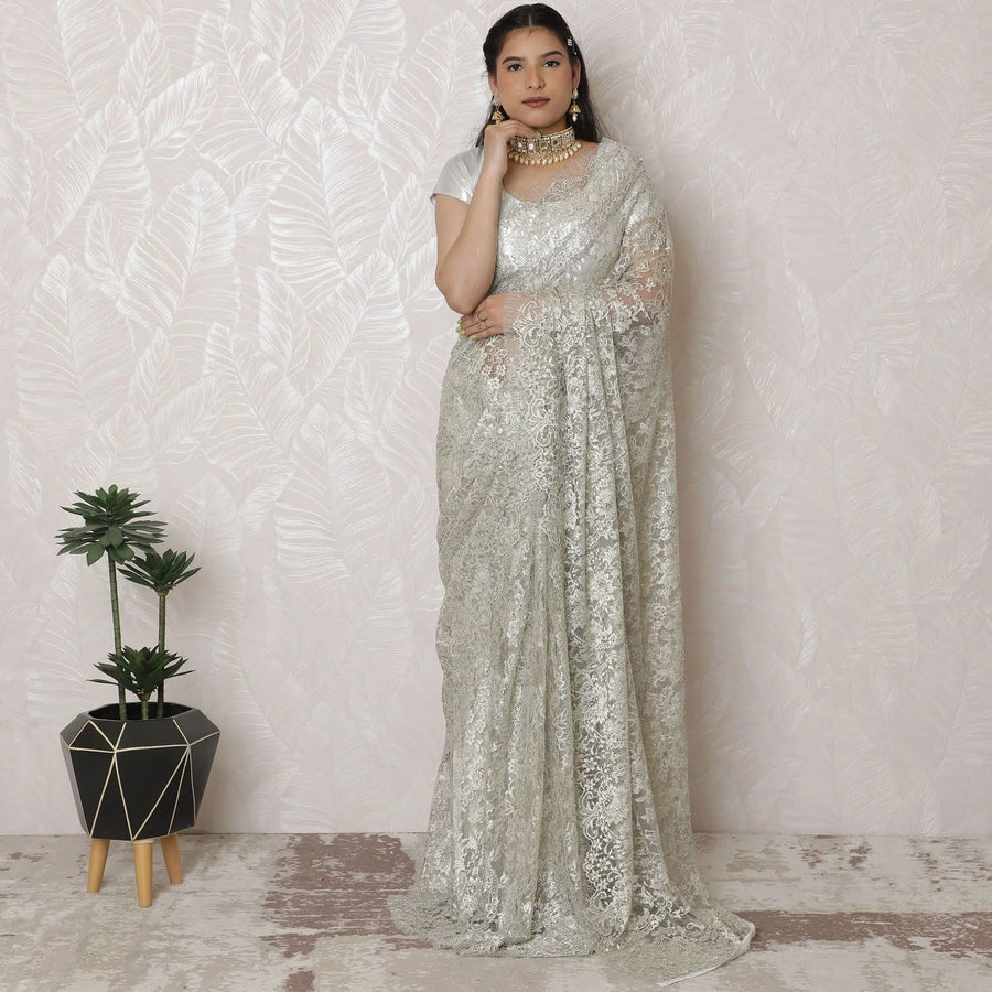 Luxurious Silver Metallic Lace Saree, French-Designed, 110cm Width, Stone Embellishments, 5.5m Length â€“ Blouse Piece Not Included
-D17866 Regal Fabrics