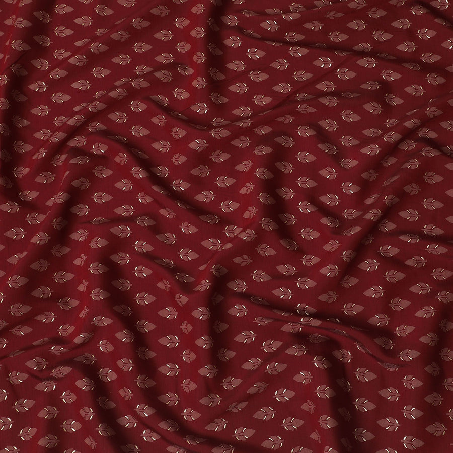 Maroon Synthetic blended cotton fabric with brick red and gold foil print in floral design-D16738