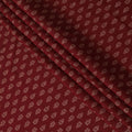 Maroon Synthetic blended cotton fabric with brick red and gold foil print in floral design-D16738
