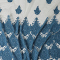 Beige nylon tulle fabric with dark Turkish blue embroidery in fancy design