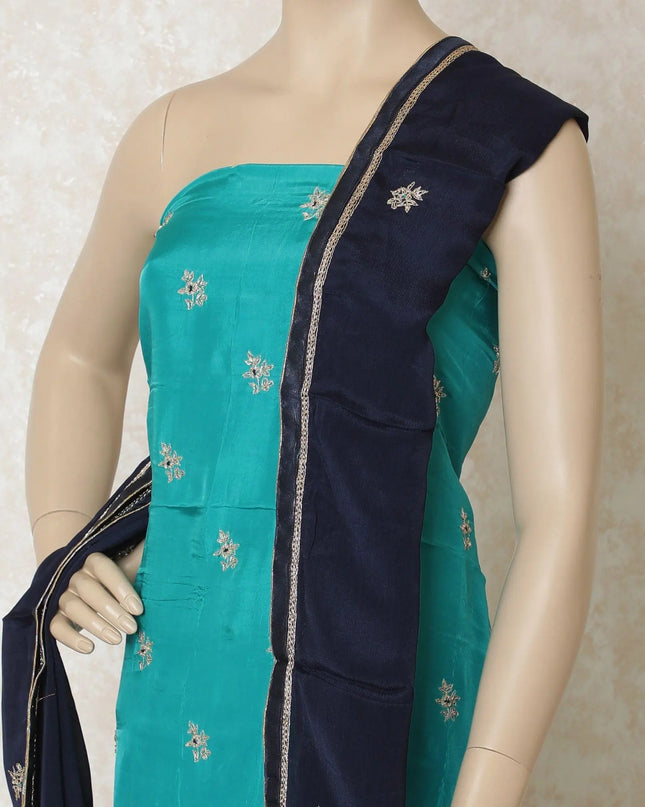 Turquoise blue silk kameez with gold embroidery having sequin work and bead work in floral design. Navy blue plain salwar having same tone chiffon dupatta with gold bead work-D12697 Regal Fabrics