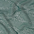 Emerald green and gold metallic lace fabric in abstract design