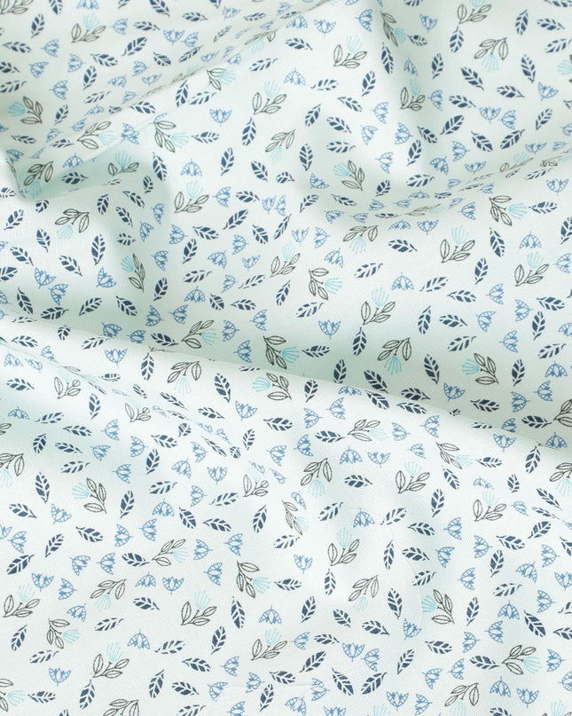 Light vista green blended cotton shirting fabric with blue and black print in leaf design-D9633