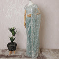 Light teal Premium net saree with same tone embroidery having light pink sequin work and gold bead work in floral design-D15586