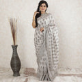 Pearl grey tussar silk saree with same tone, brown and forest green embroidery having stone work in floral design-D13490