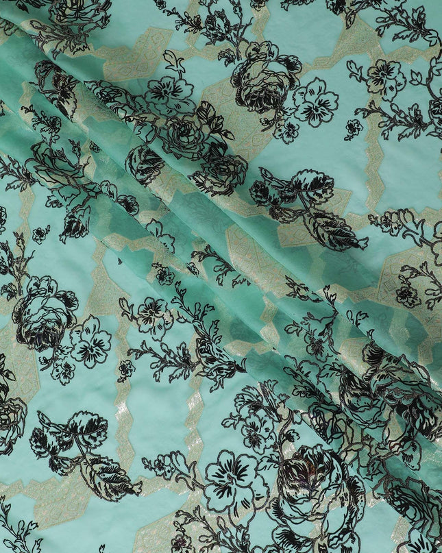 Light teal premium pure silk chiffon fabric with black flock having glitter and gold metallic lurex in floral design-D13723