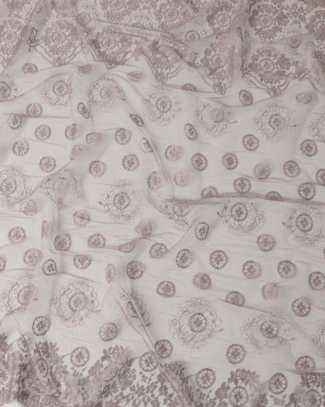 Light rouge pink nylon tulle fabric with embroidery in fancy, floral and circular design