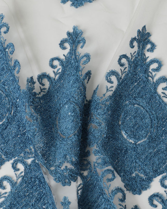Beige nylon tulle fabric with dark Turkish blue embroidery in fancy design
