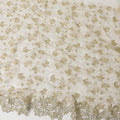 Honeysuckle beige nylon tulle fabric with gold floral embroidery and fancy border in floral design