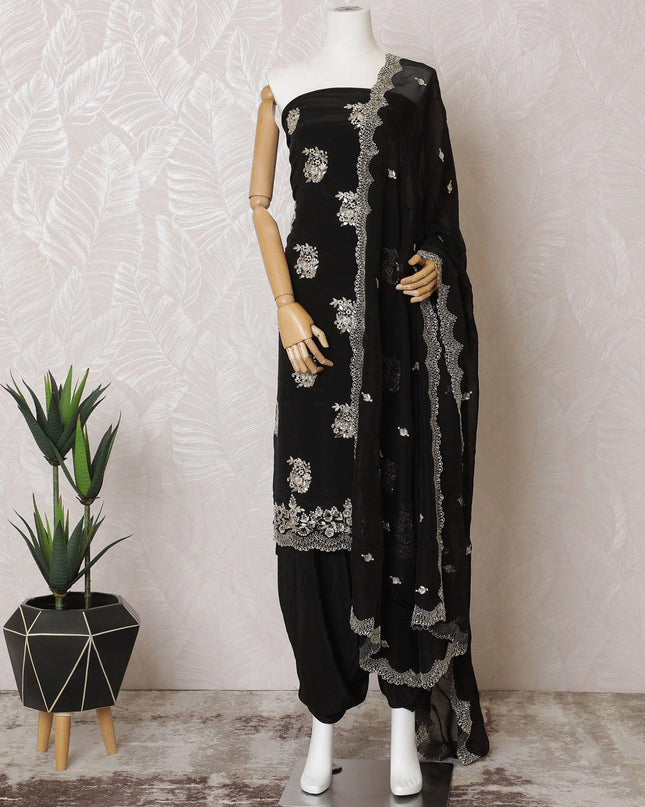 Black silk crepe kameez with gold embroidery, sequins and bead work in floral design. Black plain salwar with same tone flat chiffon dupatta having gold embroidery and mirror work-D15529