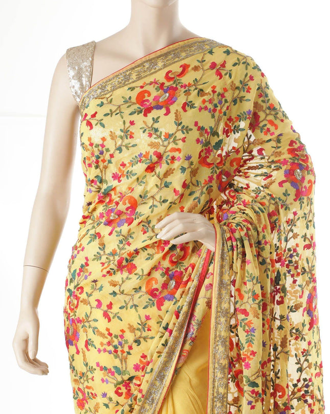 Light mustard yellow blended synthetic chiffon saree with multicolor embroidery in fancy design having multicolor bead work