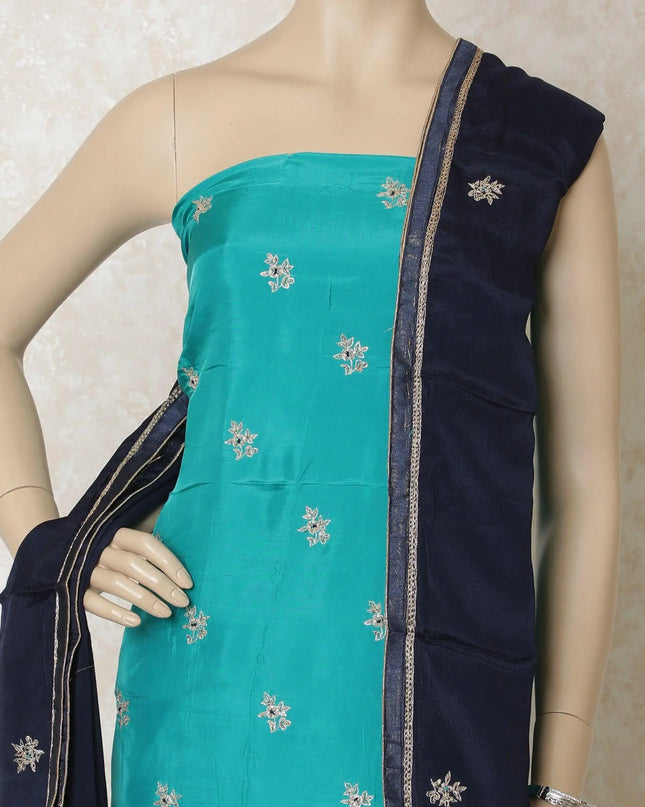 Turquoise blue silk kameez with gold embroidery having sequin work and bead work in floral design. Navy blue plain salwar having same tone chiffon dupatta with gold bead work-D12697 Regal Fabrics