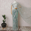 Light teal Premium net saree with same tone embroidery having light pink sequin work and gold bead work in floral design-D15586
