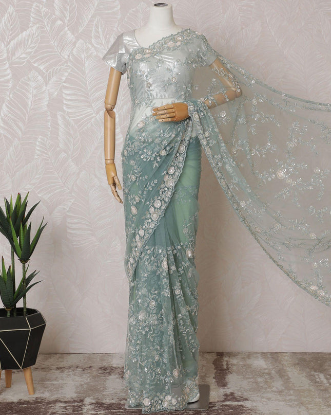 Light teal Premium net saree with same tone embroidery having light pink sequin work and gold bead work in floral design-D15586