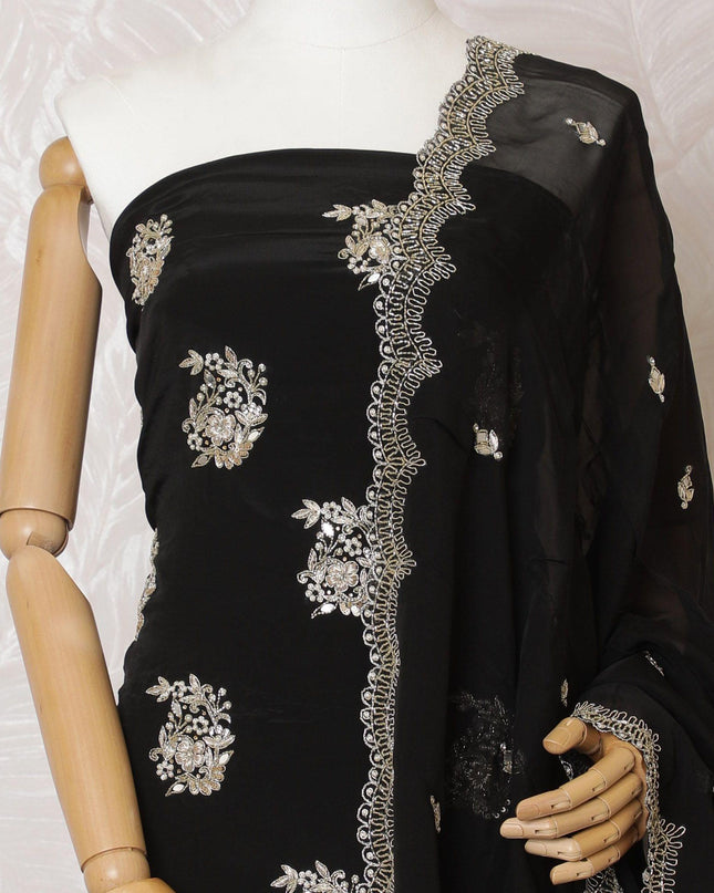Black silk crepe kameez with gold embroidery, sequins and bead work in floral design. Black plain salwar with same tone flat chiffon dupatta having gold embroidery and mirror work-D15529