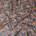 Petrol blue tussar silk fabric with olive green, tangerine orange, blonde yellow and light plum print in floral design-D6140 Regal Fabrics