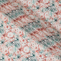 Off white synthetic crepe fabric with forest green, squash orange and black print in floral design-D11034