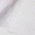 Baby pink nylon tulle fabric with white embroidery in floral design