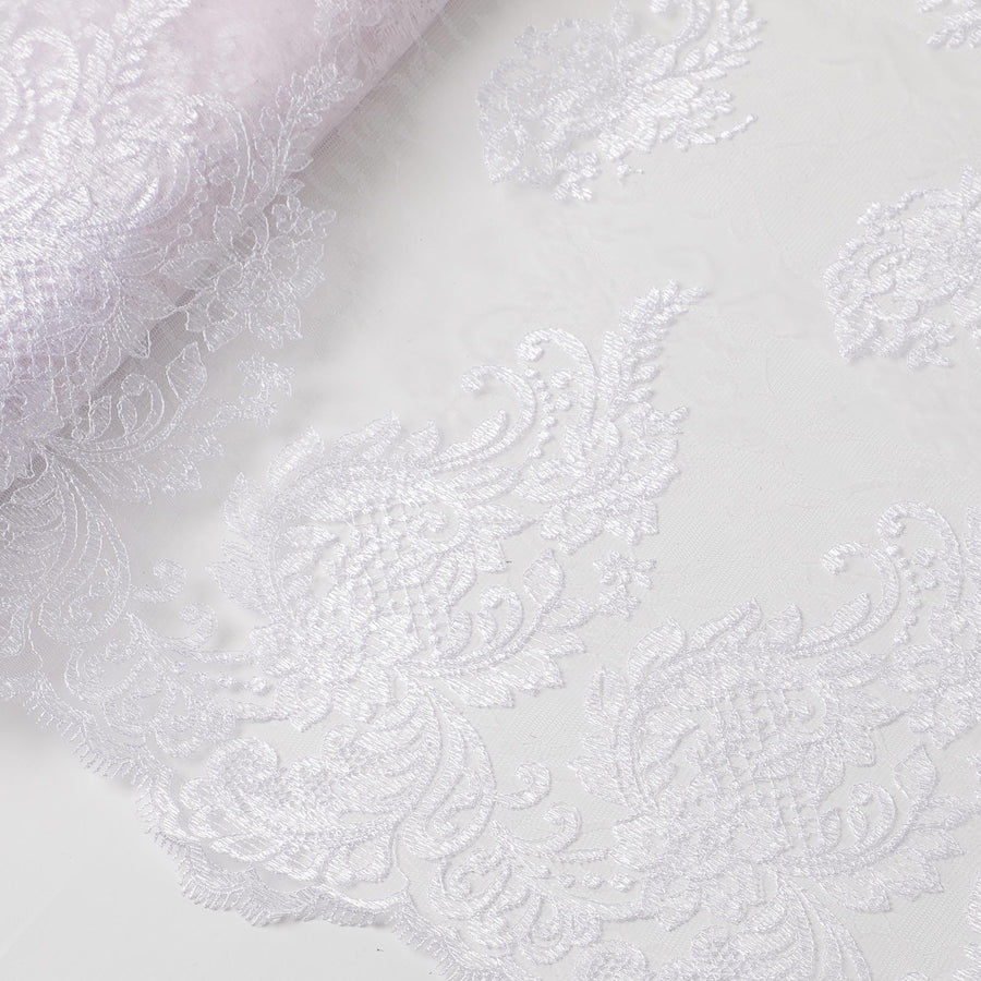 Baby pink nylon tulle fabric with white embroidery in floral design