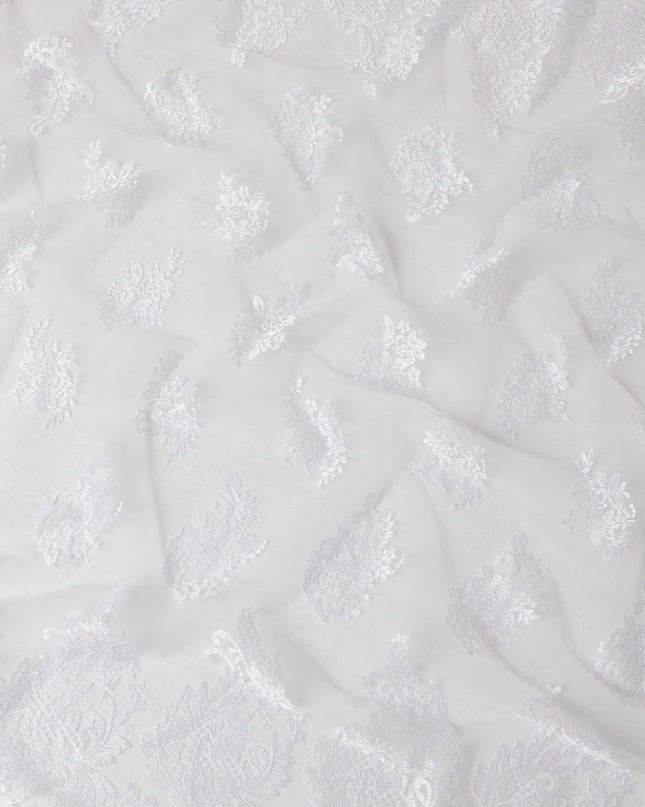 Baby pink nylon tulle fabric with white embroidery in floral design