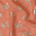 Creamsicle orange synthetic georgette fabric with same tone embroidery having gold foil print in floral design-D12032