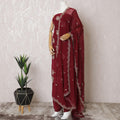 Ruby red silk crepe kameez with gold embroidery, sequins and bead work in floral design. Ruby red plain salwar with same tone flat chiffon dupatta having gold embroidery and mirror work-D15530