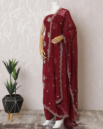 Ruby red silk crepe kameez with gold embroidery, sequins and bead work in floral design. Ruby red plain salwar with same tone flat chiffon dupatta having gold embroidery and mirror work-D15530