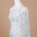 Off white nylon tulle fabric with same tone and light teal blue embroidery having sequins in floral design-D9243