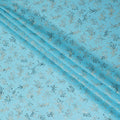 Sky blue Premium pure cotton voile fabric with gold and bottle green print in floral design-D13171